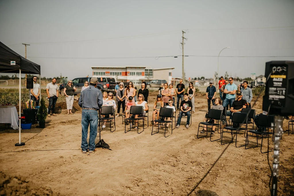 Community members gathered outdoors for an opening ceremony