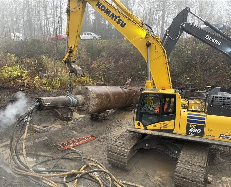 Excavator lifting pipe at Meziadin Junction