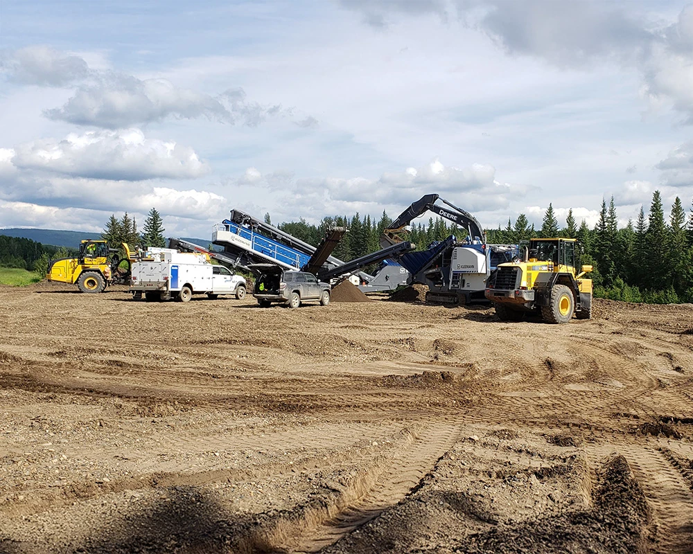 Crushing and screening plant with a loader and aggregate stockpiles